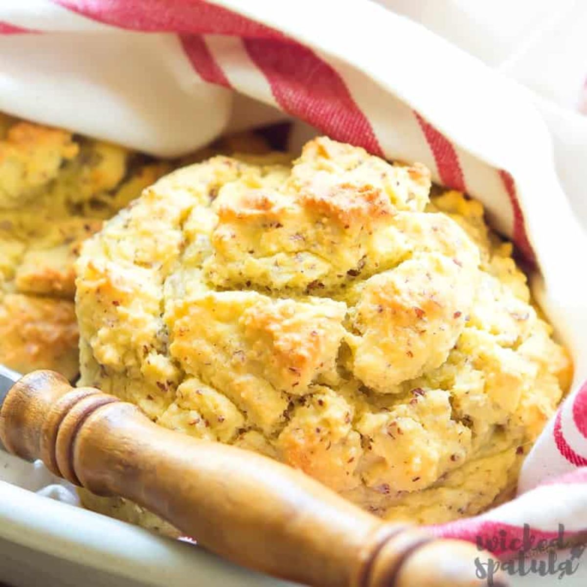 a cloth covered basket with 2 large biscuits in it