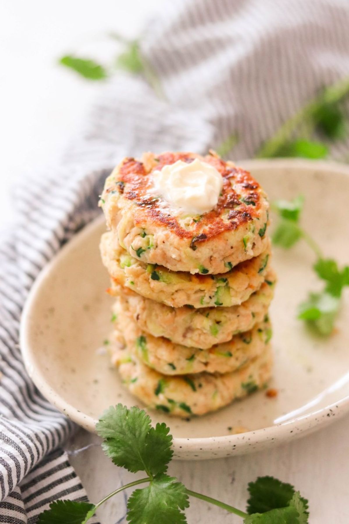 a stack of salmon cakes garnished with herbs