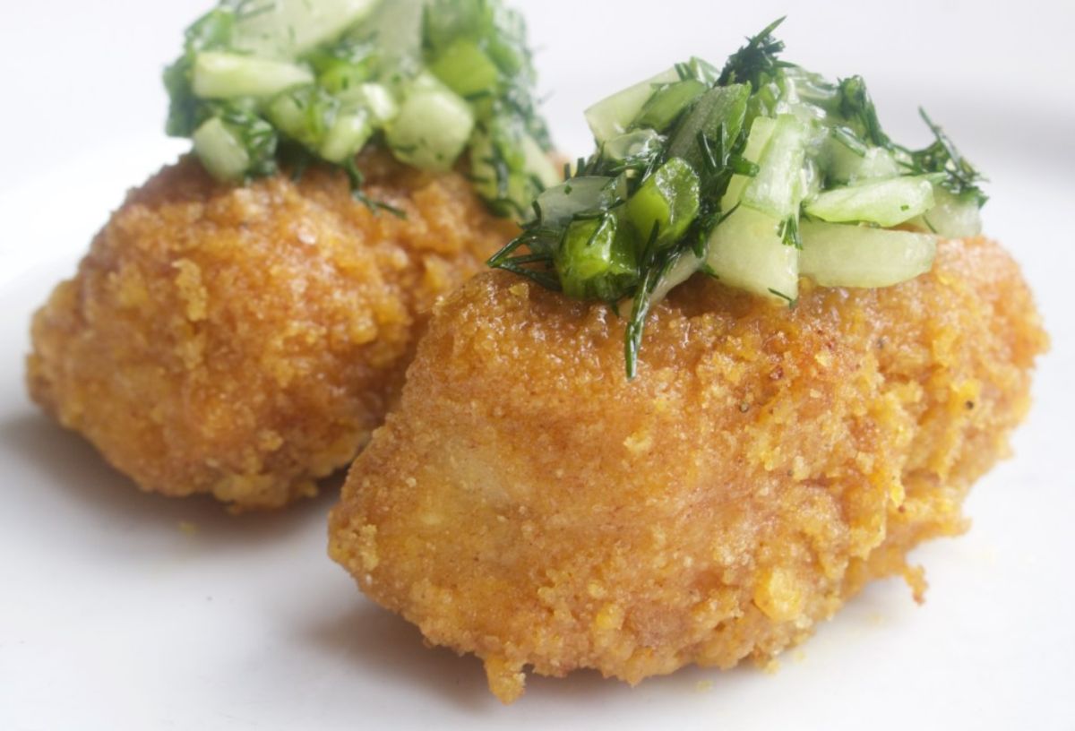 two fish goujons topped with cucumber relish