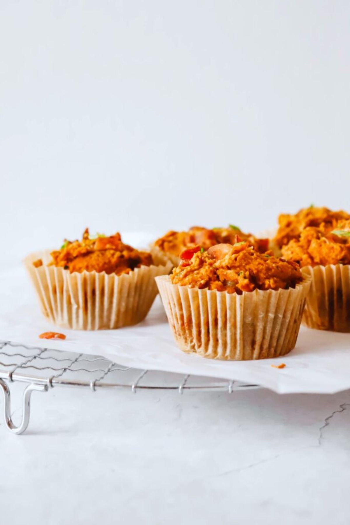 a cooling tray laden with sweet potato bacon and chive muffins