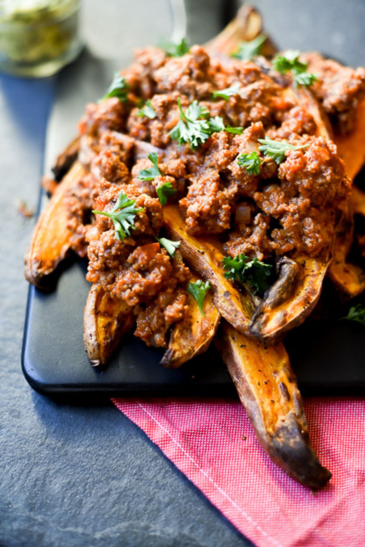 a plate of sweet potato fries covered in sloppy joes