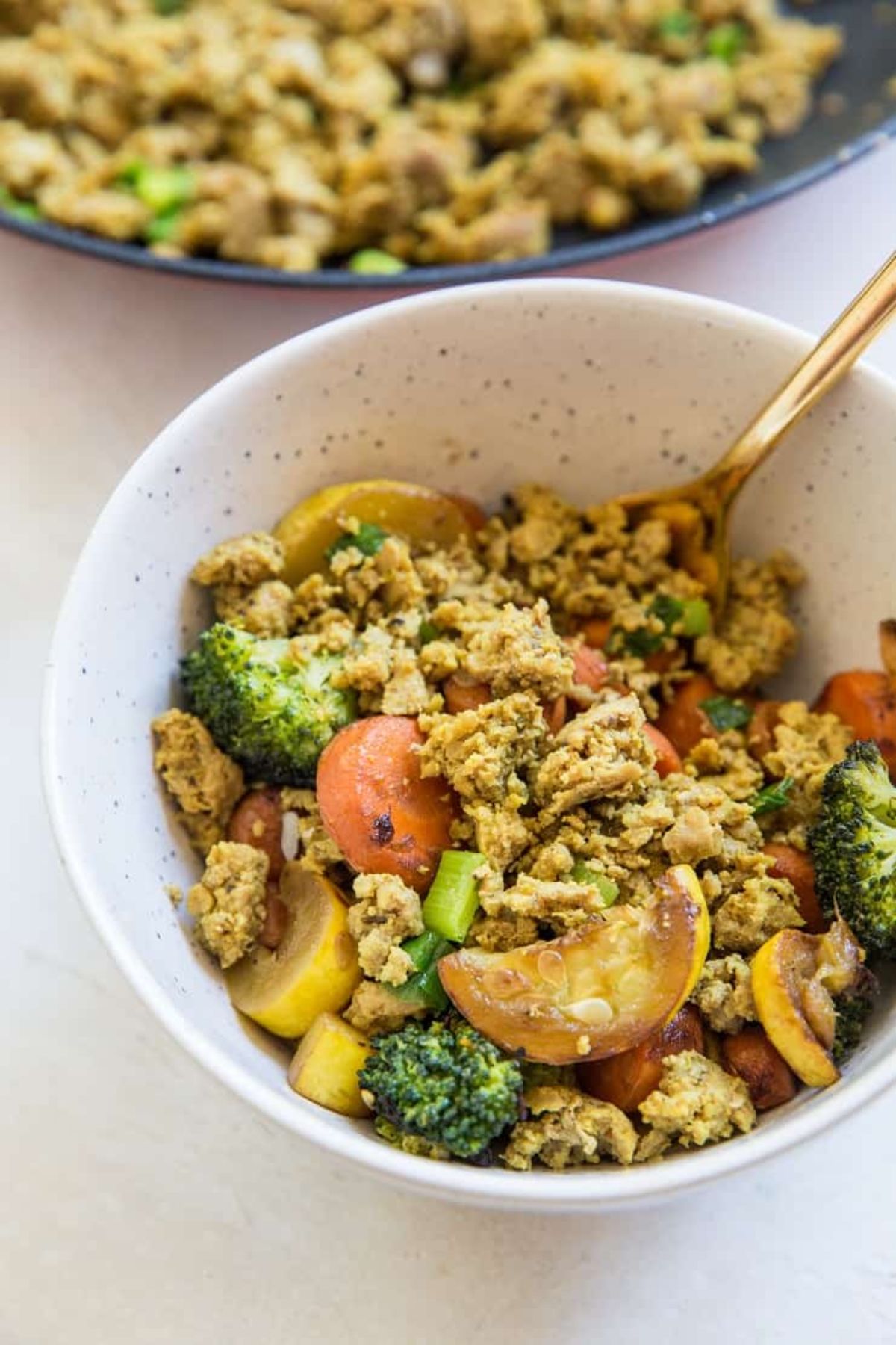 A white bowl of ground turkey and vegetables