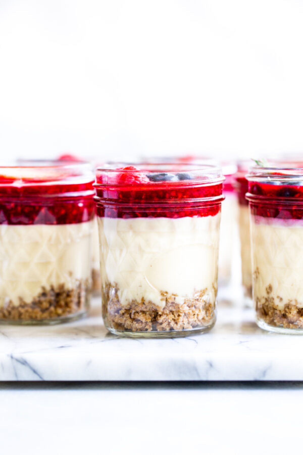 3 jars filled with layered cheesecake