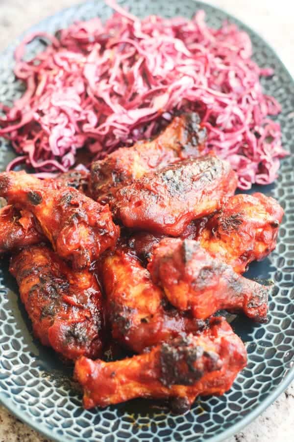 Overhead Shot of Honey BBQ Chicken Wings WIth Slaw On Blue Plate