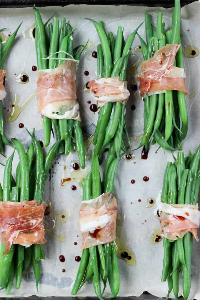 Crispy Prosciutto Wrapped Balsamic Green Beans on a baking tray