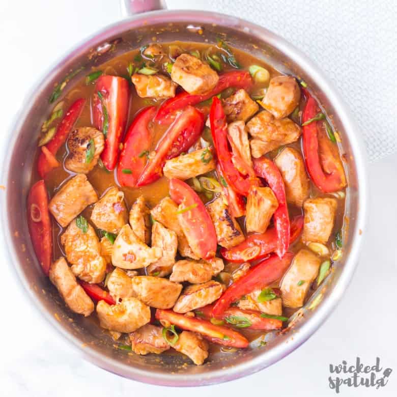 overhead shot orange chicken with tomatoes