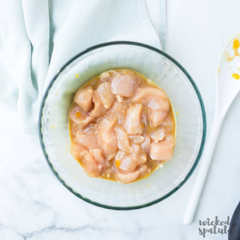 chicken and pineapple stir fry marinating in bowl