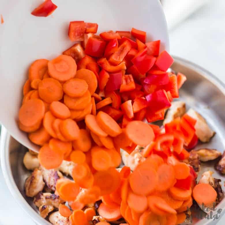 adding vegetables to pan for pineapple stir fry