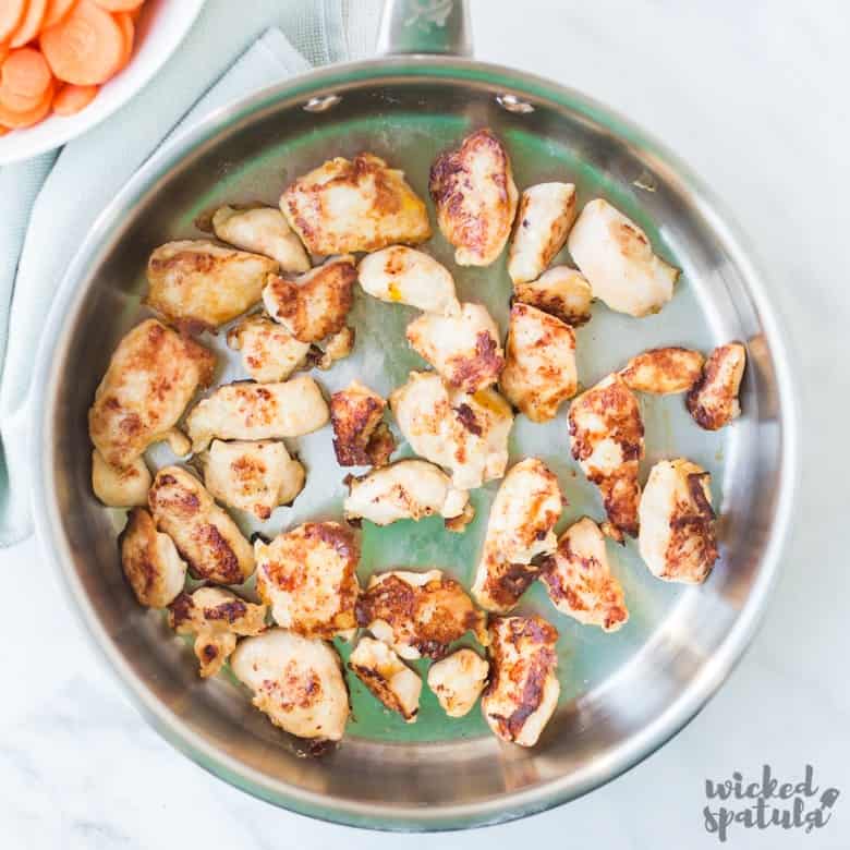 sweet and sour chicken stir fry in a pan