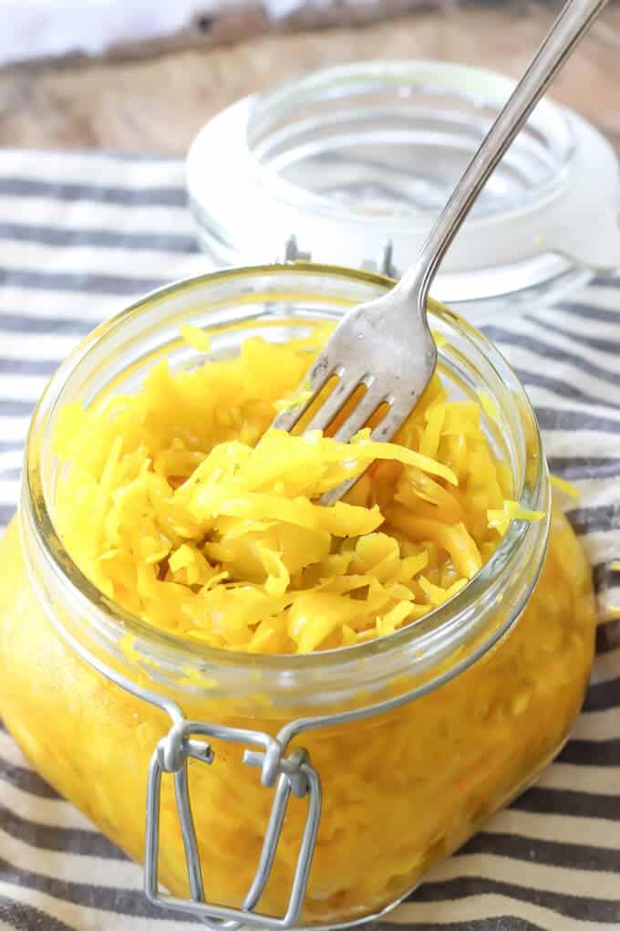 DIY Turmeric Jalapeño Sauerkraut in jar with a fork