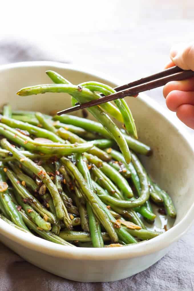 Overhead Shot Of Spicy Asian Green Beans In White Bowl With Chopsticks