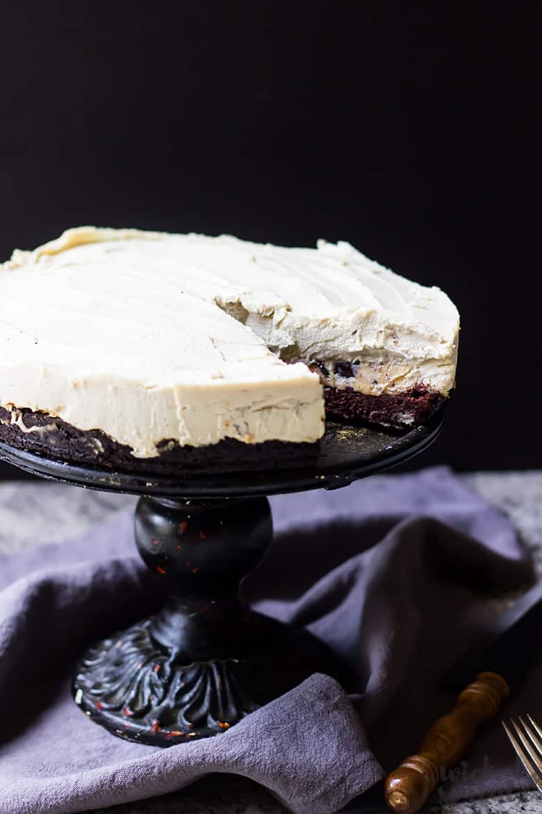 whole paleo cheesecake on a cake stand