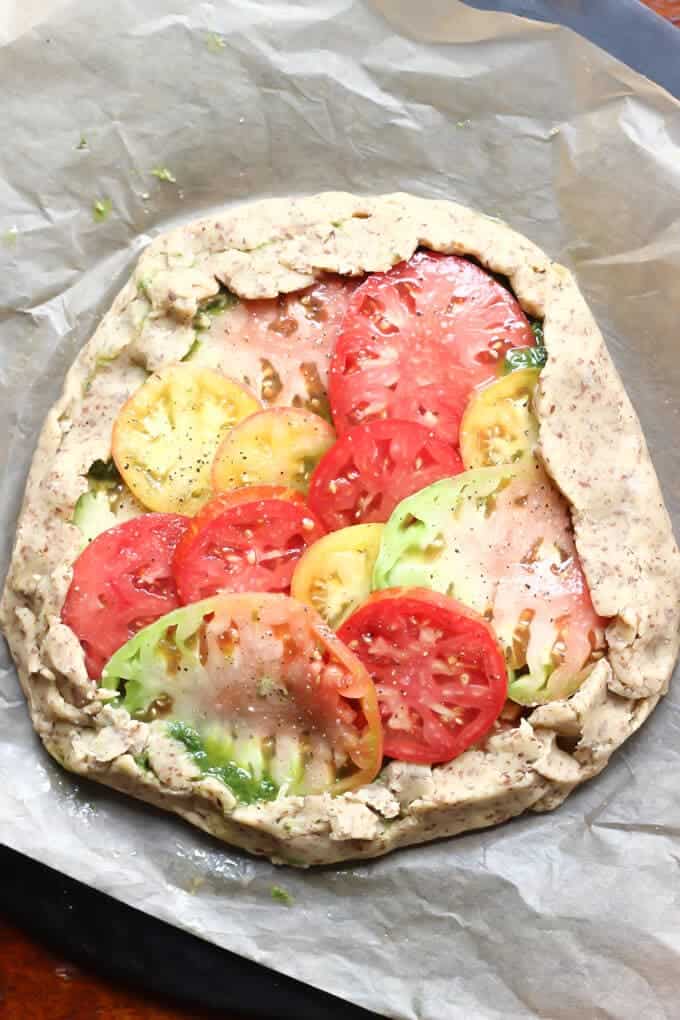 Rustic Paleo Tomato Galette with Arugula Basil Pesto on a baking tray