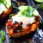 healthy stuffed sweet potatoes topped with avocado ready to eat