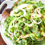 arugula apple salad in a bowl