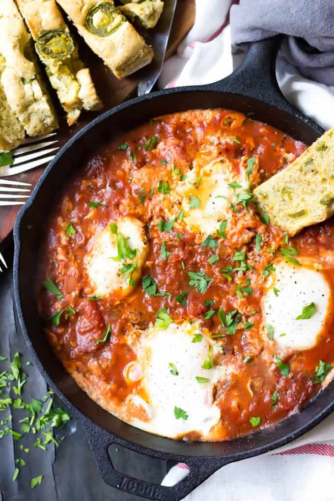 Easy Paleo Eggs In Hell Recipe - Eggs In Hell in Pan With Bread on plate.