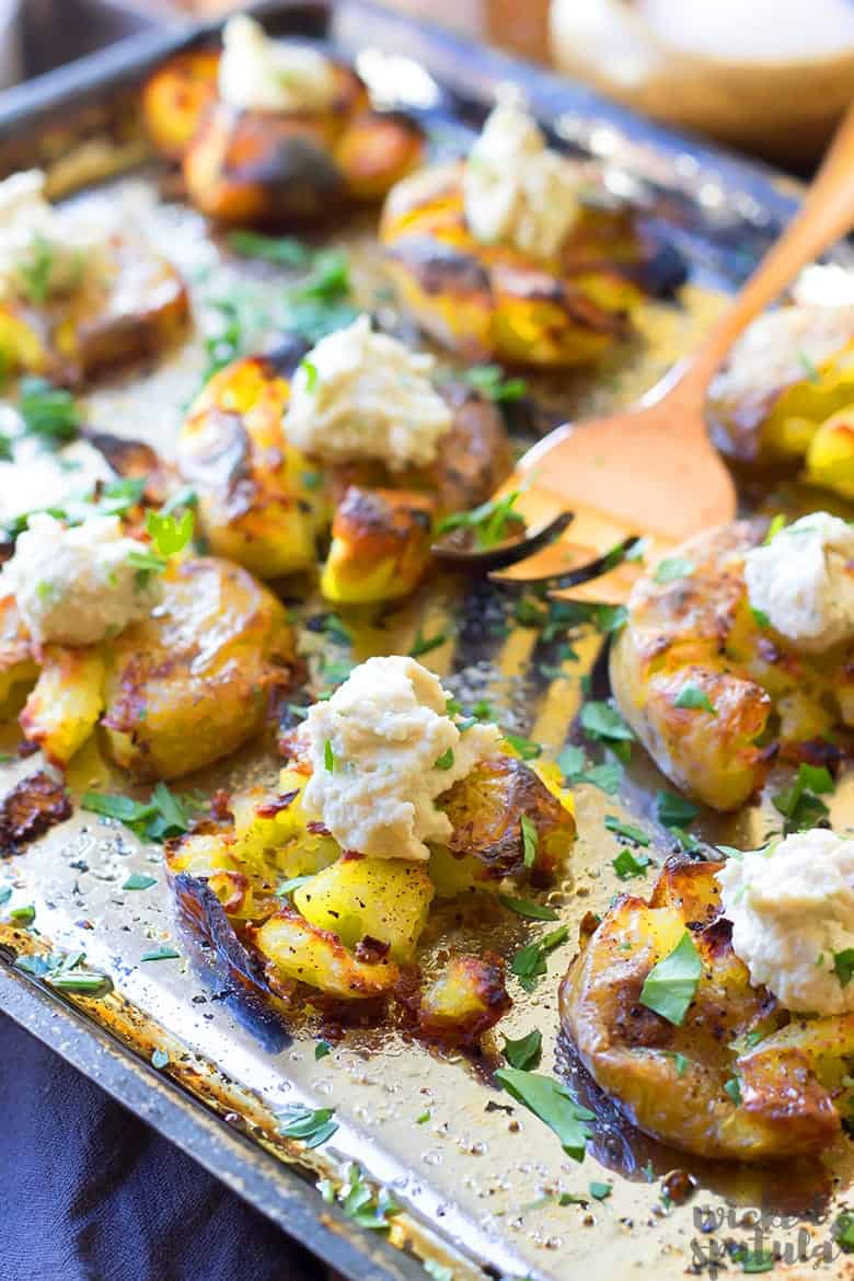 roasted smashed potatoes with a fork