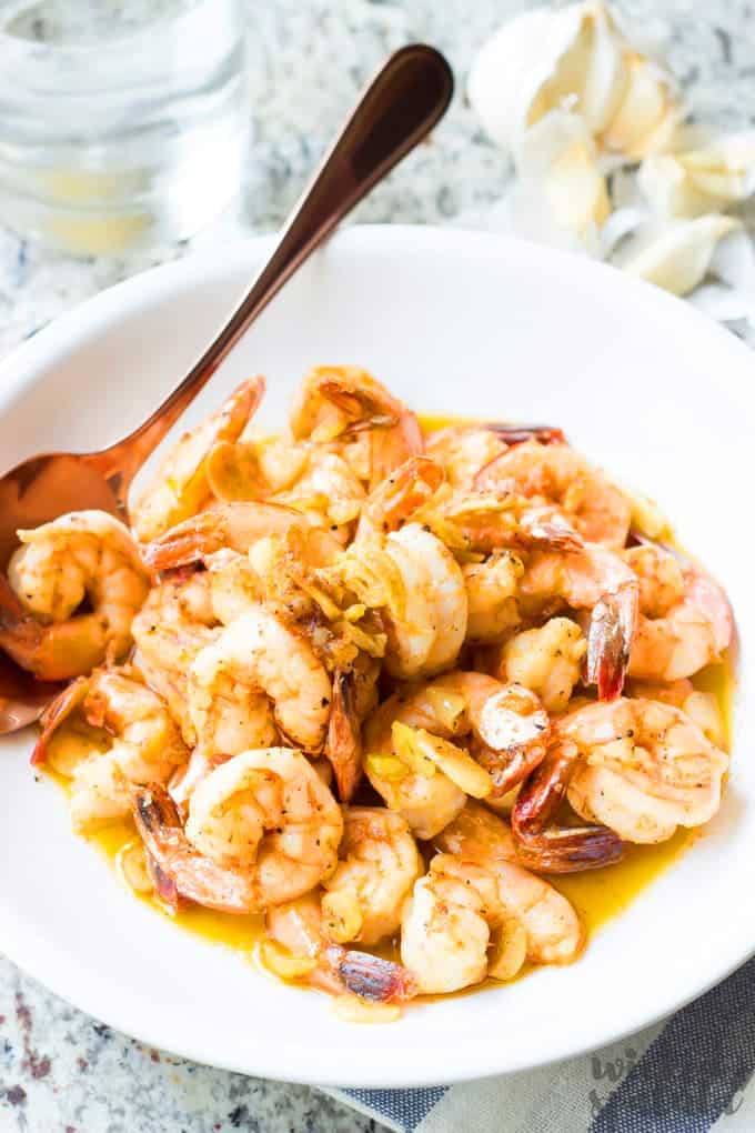 gambas al ajillo in a bowl with a spoon