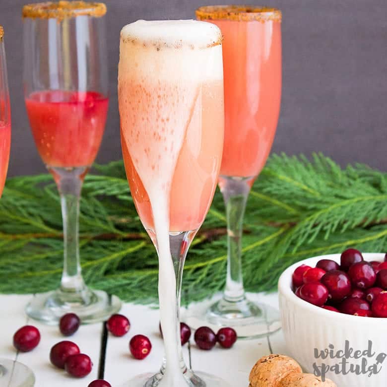 cranberry mimosa overflowing champagne glass