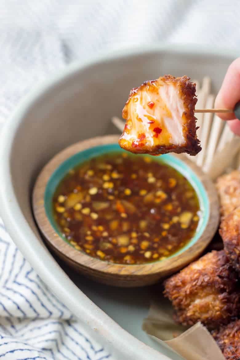 Quick Paleo Coconut Salmon Bites dipped in chili sauce