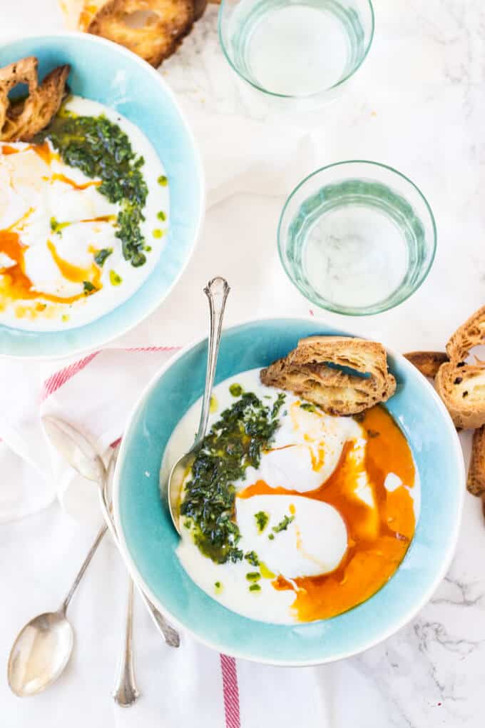 Turkish Poached Eggs - Garlic infused yogurt gets topped with poached eggs, spiced browned butter, and a fragrant chimichurri