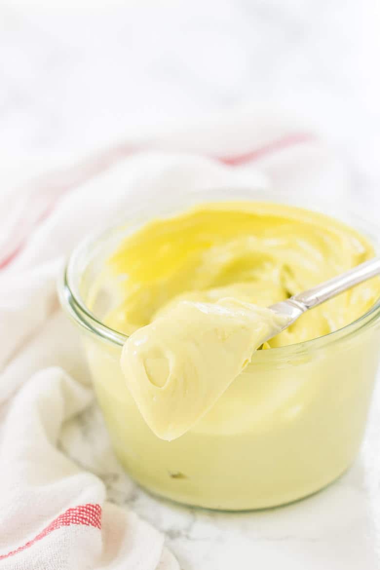 Image Of Thick Avocado Mayo In Glass Jar With Knife