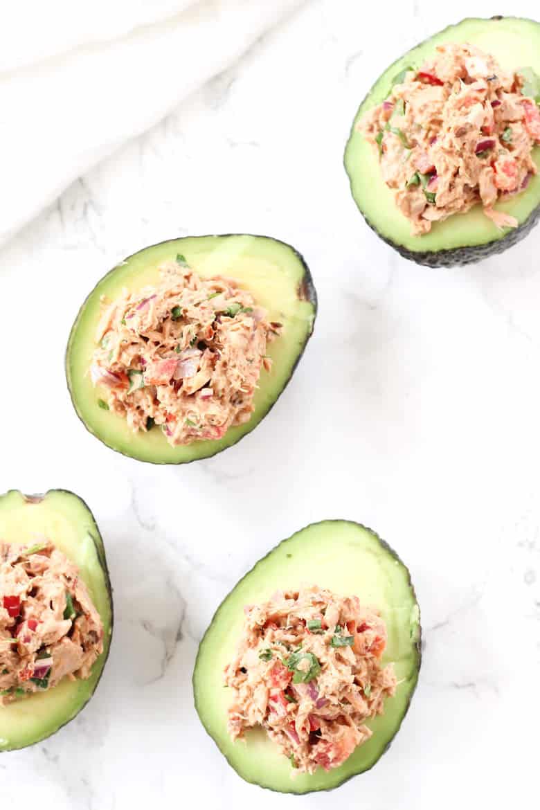 Overhead Shot Of Tuna Stuffed Avocados On Marble Surface