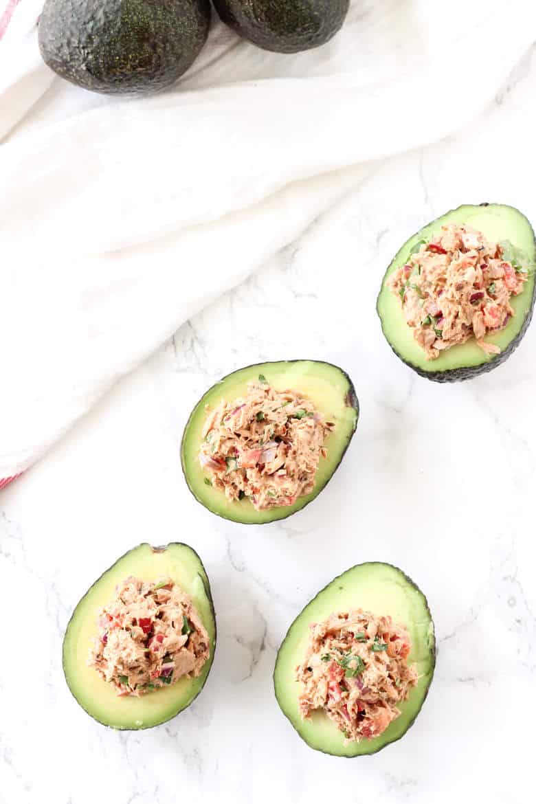 Overhead Shot Of Tuna Stuffed Avocados On Marble Surface