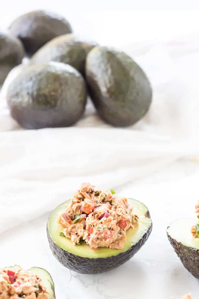 Side Shot Of Tuna Stuffed Avocados With Whole Avocados