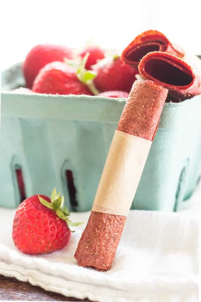 Homemade Roll of Strawberry Fruit Leather With Carton Of Fresh Strawberries