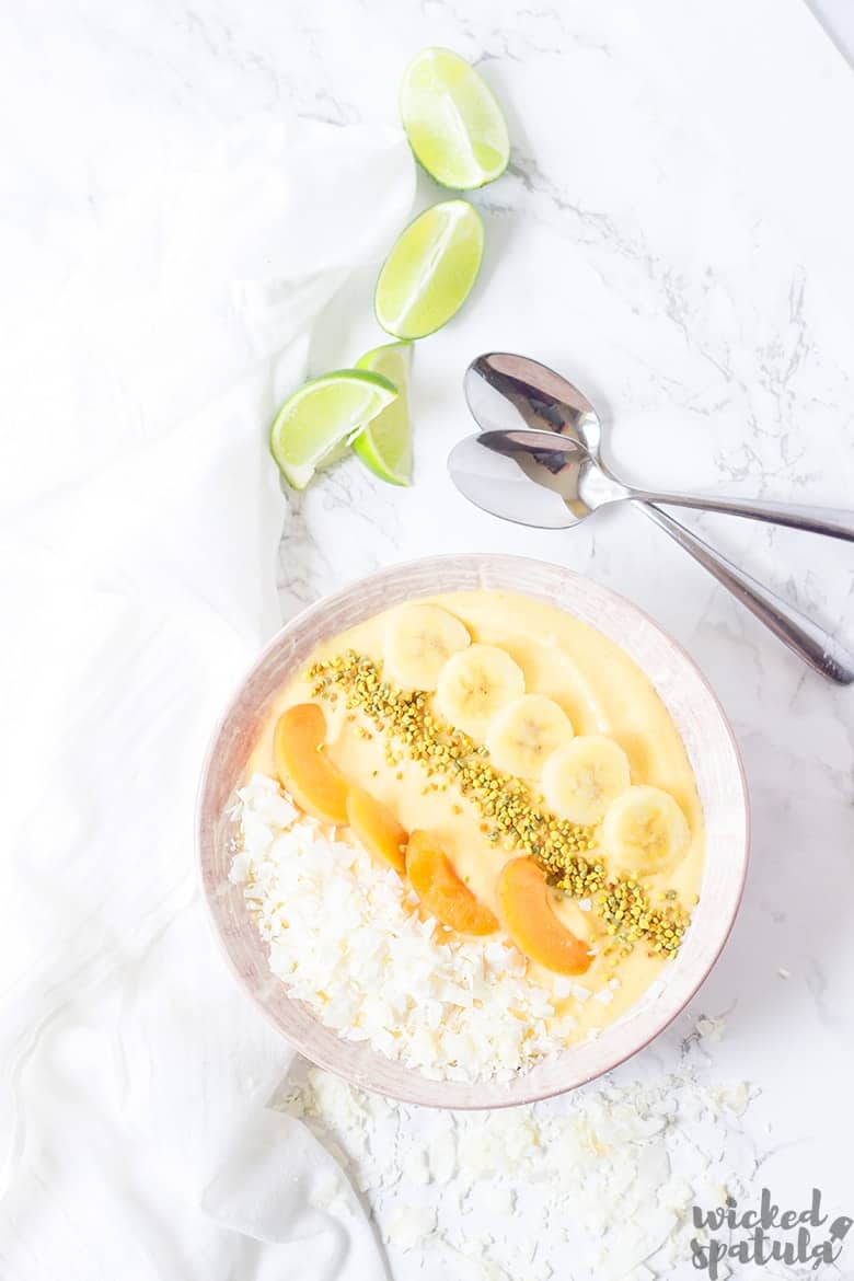 Tropical Smoothie Bowl with lime wedges