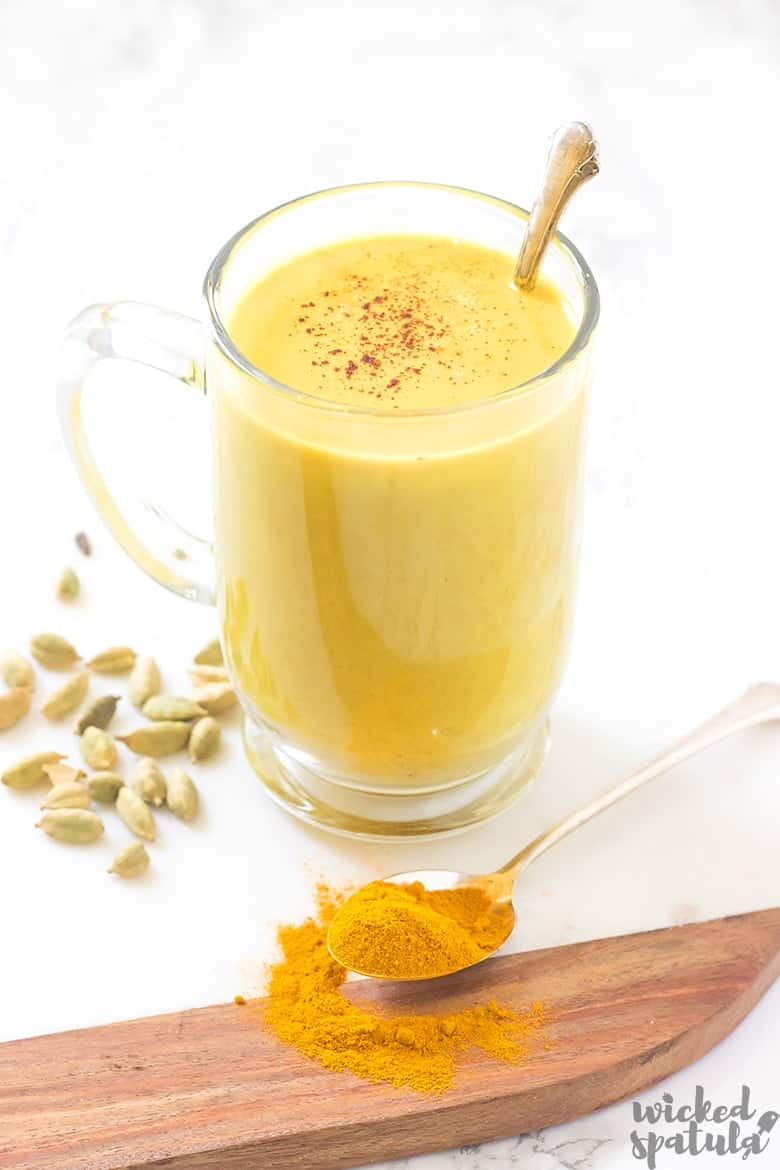 golden turmeric latte in mug with spoon