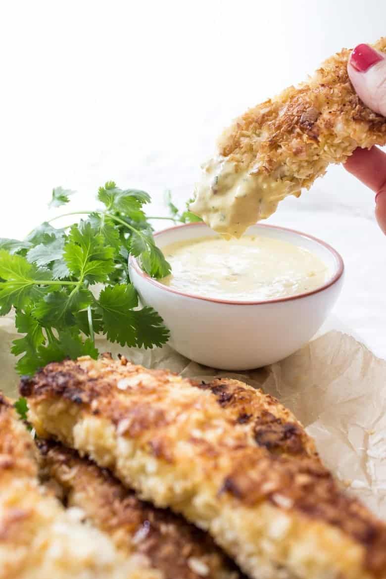 Woman dipping chicken tenders