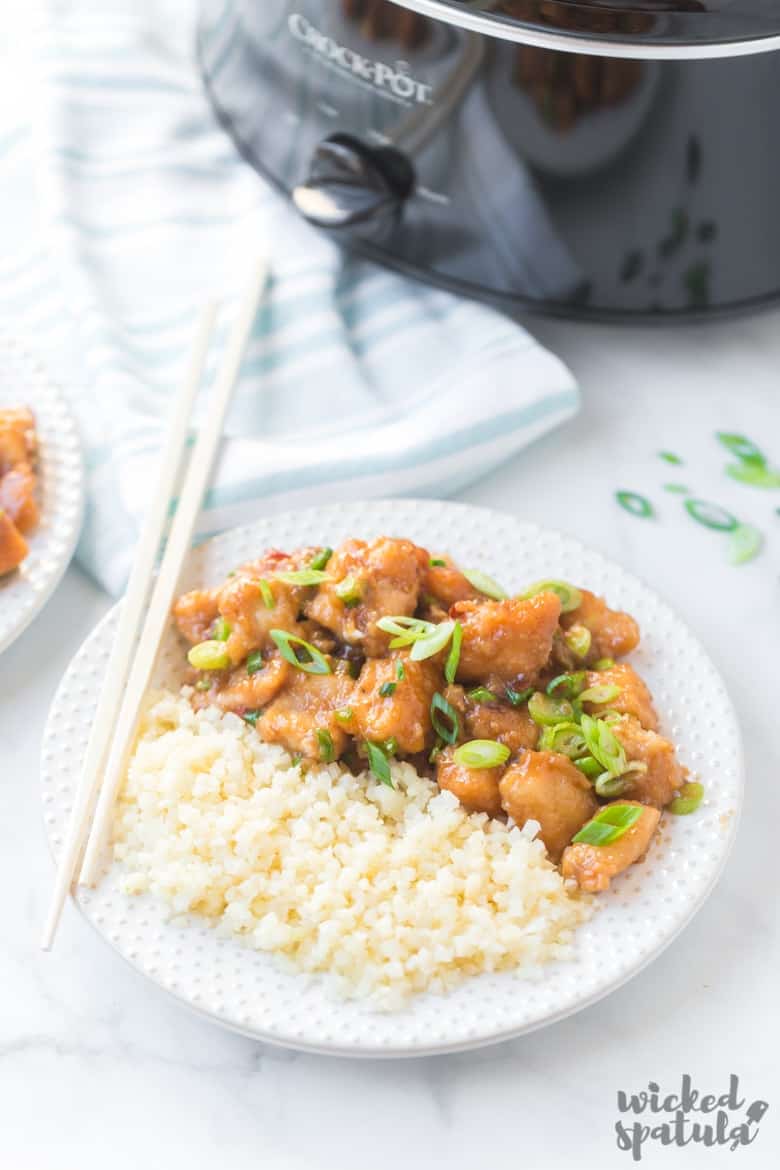 healthy general tso chicken on plate with chopsticks