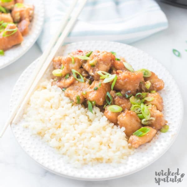 Crock Pot General Tso chicken on a plate with cauliflower