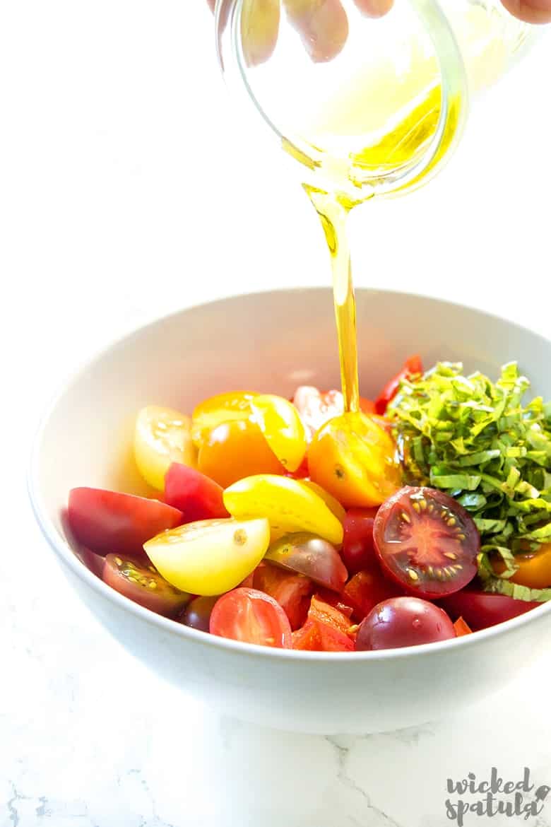 tomatoes being drizzled by olive oil