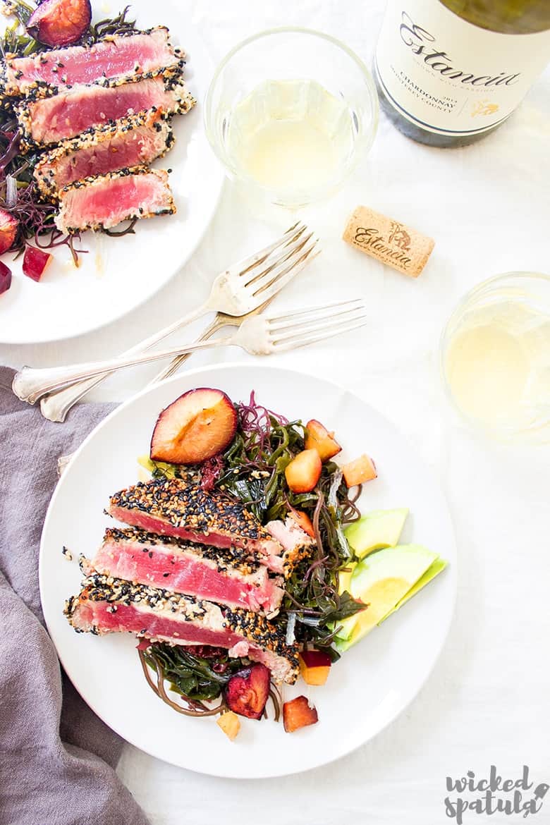 ahi tuna salad on a plate with wine