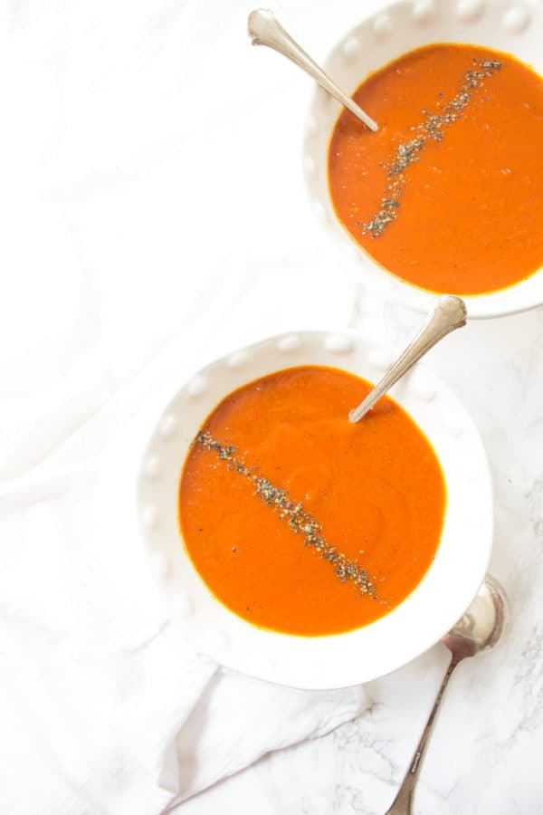This Slow Cooker Roasted Red Pepper Tomato + Turmeric Soup is packed full of flavor, antioxidants, and anti-inflammatory properties and is delicious on a brisk evening.