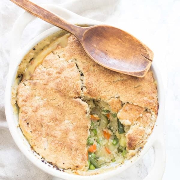 Overhead Shot Of Paleo Vegan Pot Pie In Pie Dish With Wooden Spoon