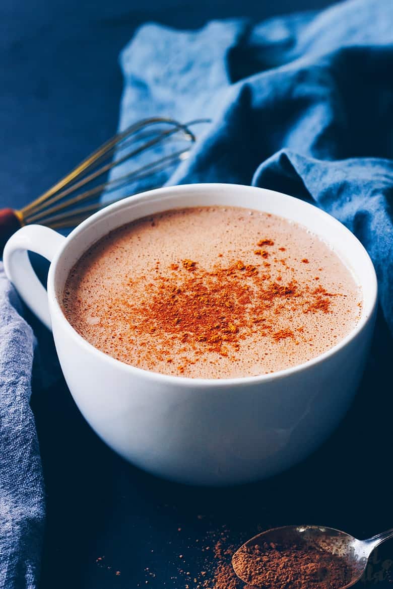 coconut milk hot chocolate in a mug with cocoa sprinkle