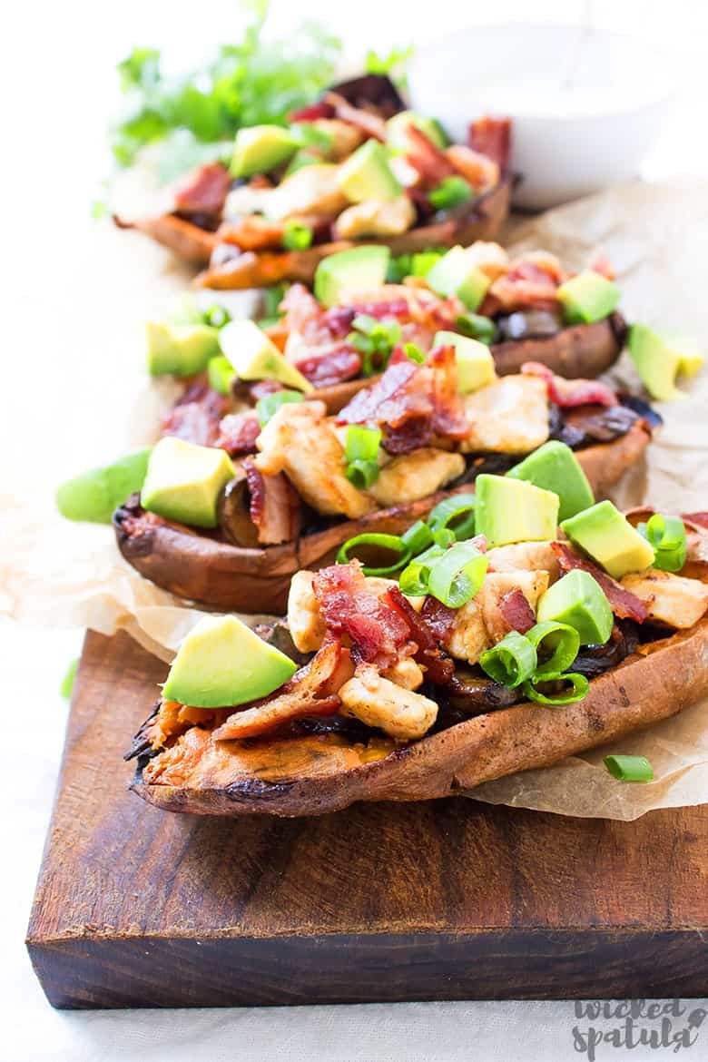 baked potato skins on a wood cutting board