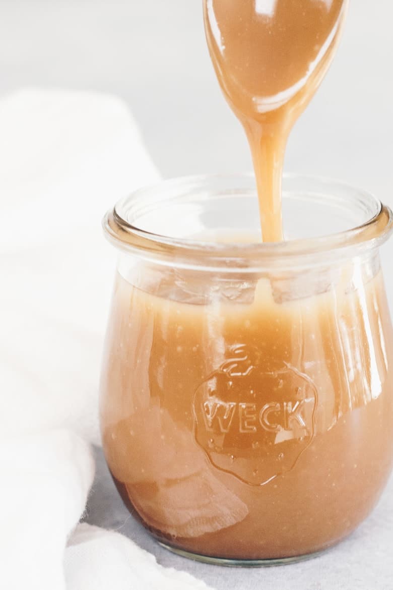 Healthy Paleo Dairy-Free Caramel Sauce Recipe - Spoon with dripping caramel sauce