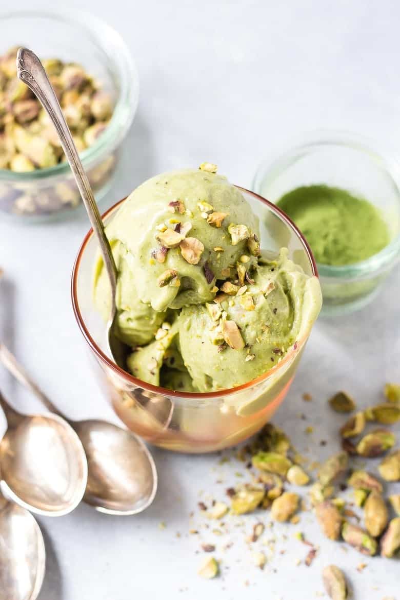 vegan pistachio ice cream with spoons and pistachios