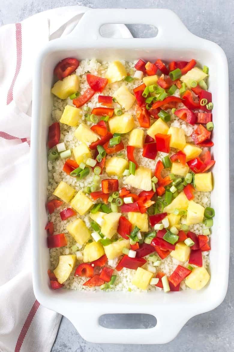 This Paleo Teriyaki Chicken Bake is loaded with cauliflower, red bell peppers, pineapple, green onions, and a quick homemade paleo teriyaki sauce!