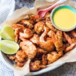 Paleo Coconut Shrimp on a platter with dipping sauce
