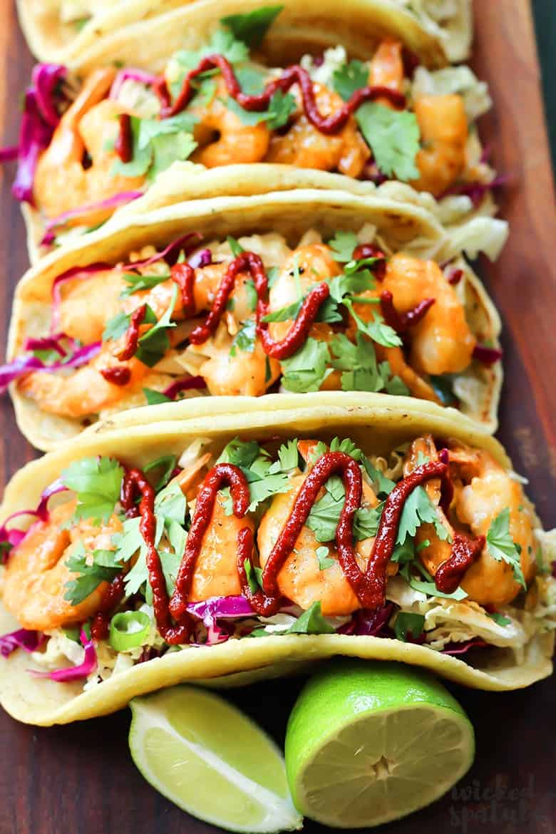 tacos drizzled with sriracha and shrimp taco sauce