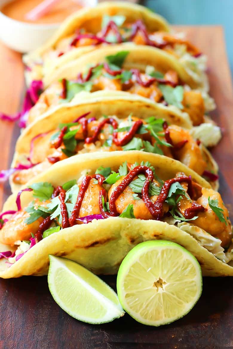 shrimp taco recipe on a platter with limes