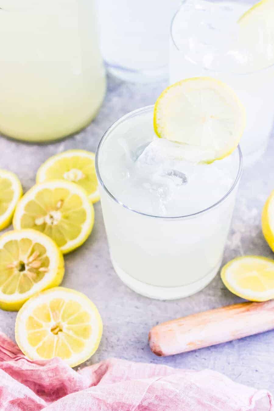 detox lemonade in a glass with cut lemons 