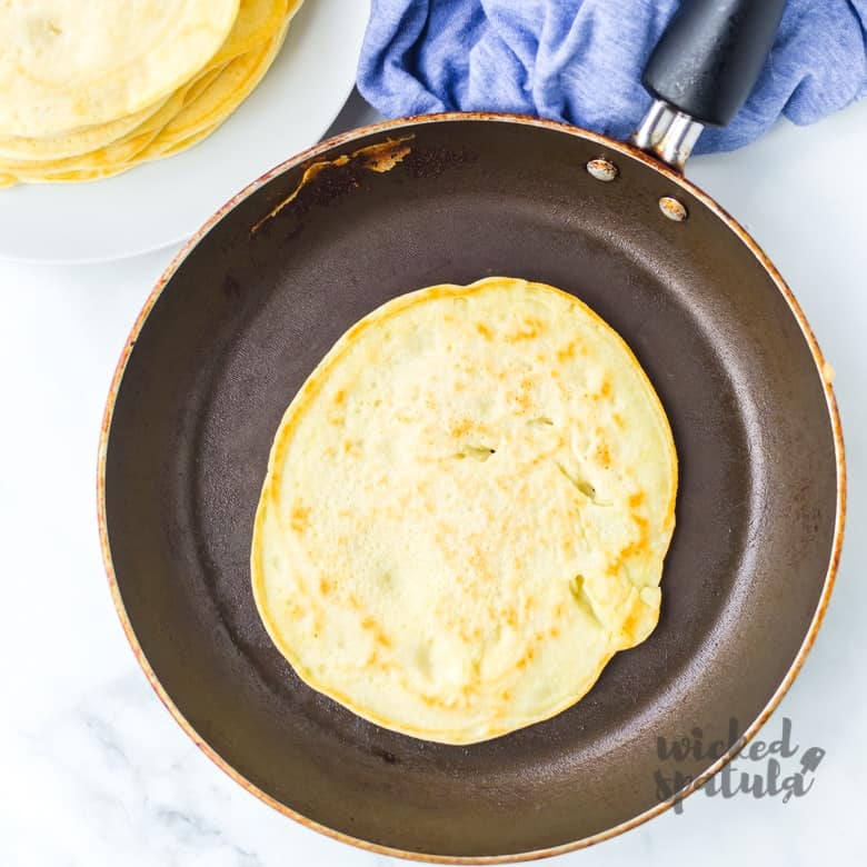 coconut flour tortillas cooking in a pan