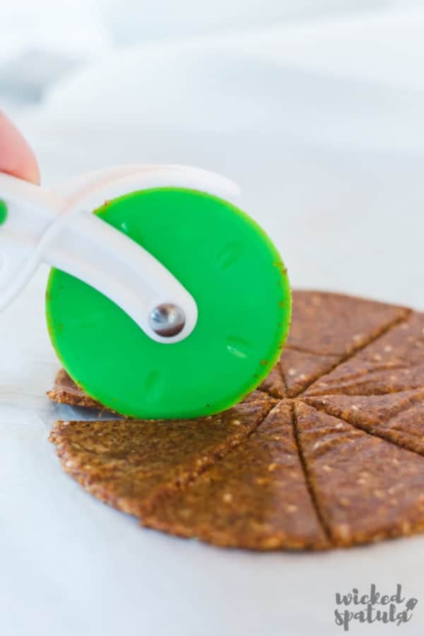paleo tortilla chips - cutting with pizza wheel
